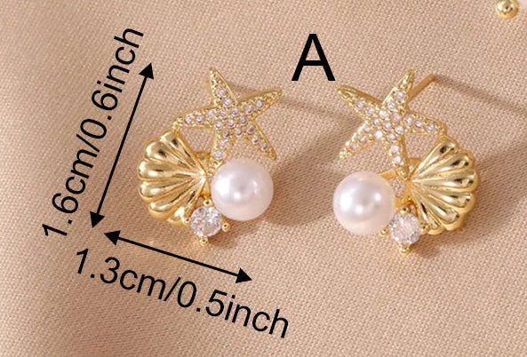 Three pairs of gold-toned statement earrings displayed on a beige fabric background, with dimension arrows and text labels A, B, and C plus weights listed in the lower right. The earrings feature large white pearl-like drops, shell charms, and starfish or shell-shaped studs.